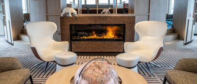 Cozy seating in front of the fireplace on the NatGeo Endurance.