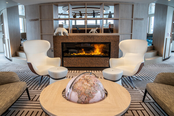 Cozy seating in front of the fireplace on the NatGeo Endurance.