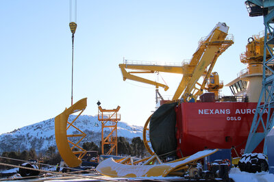 One of the dock cranes is being used to lift the first set of fairings.