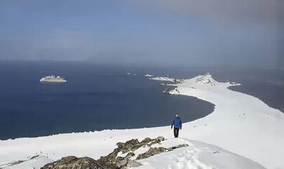 Greg Mortimer passengers hiking in Antarctica.