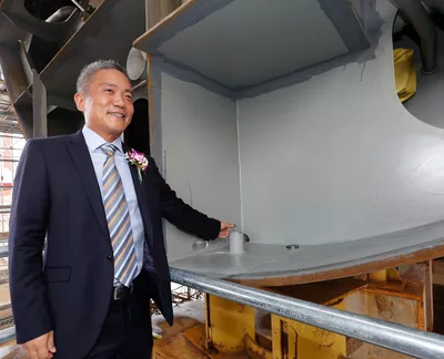 Placing a coin for good luck and fortune on the Ocean Victory.