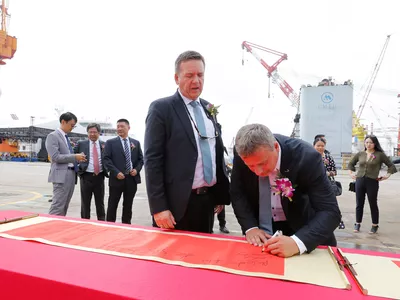 Ulstein representatives Lars Ståle Skoge and Trond Gundersby placing their signatures at the keel laying ceremony on the Ocean Victory.