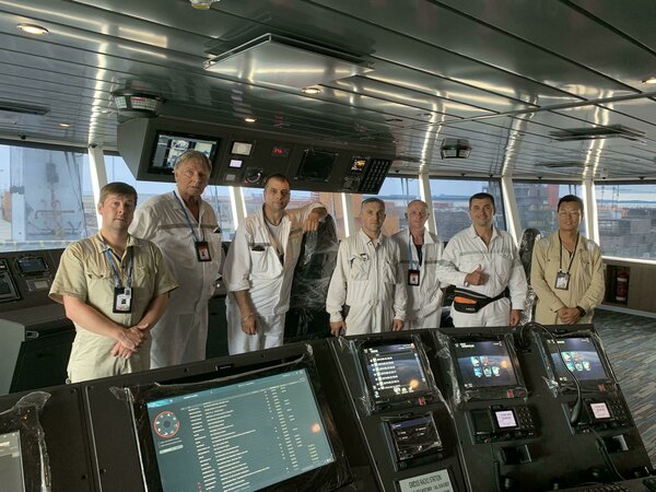 Ulstein's representative and the SunStone crew on the bridge of the 'Greg Mortimer'.