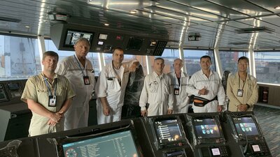 Ulstein's representative and the SunStone crew on the bridge of the 'Greg Mortimer'.