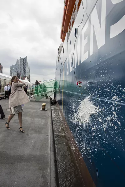 Lady sponsor Sophie Schulte blessing the ship in champagne.